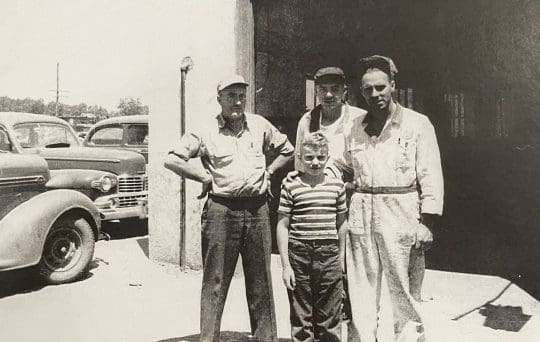 Mechanics standing in front of Royal Wheel Alignment