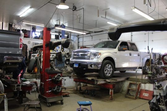 Ford Truck on an alignment rack being repaired by Royal Wheel Alignment in Rapid City